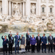 World leaders throw a coin in the water during a visit to the Trevi fountain on the second day of the Rome G20 Summit